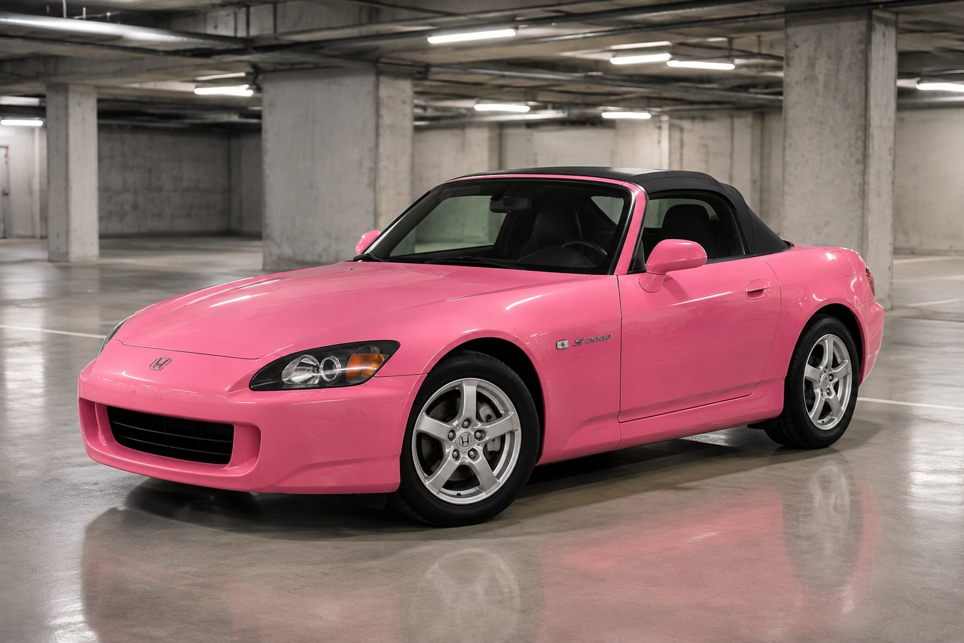 A pink Honda S2000 at stock proportions in a parking garage